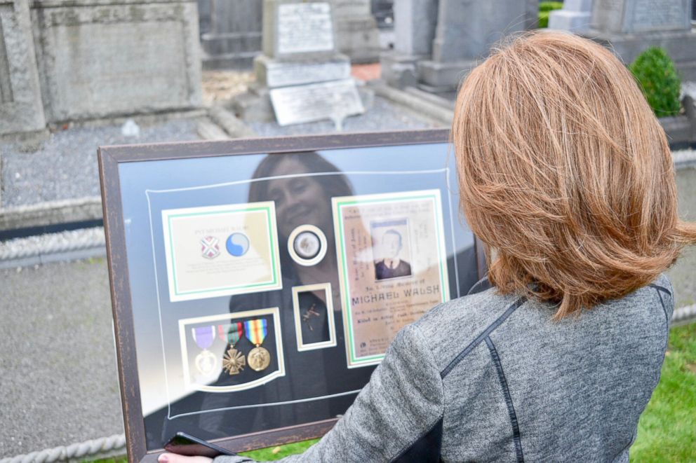 PHOTO: A family member looks at the Purple Heart medal awarded to Private Michael Walsh, killed in action during World War I on October 24, 1918. An Irish immigrant in New York, Walsh was drafted into the American Expeditionary Forces in 1917. 