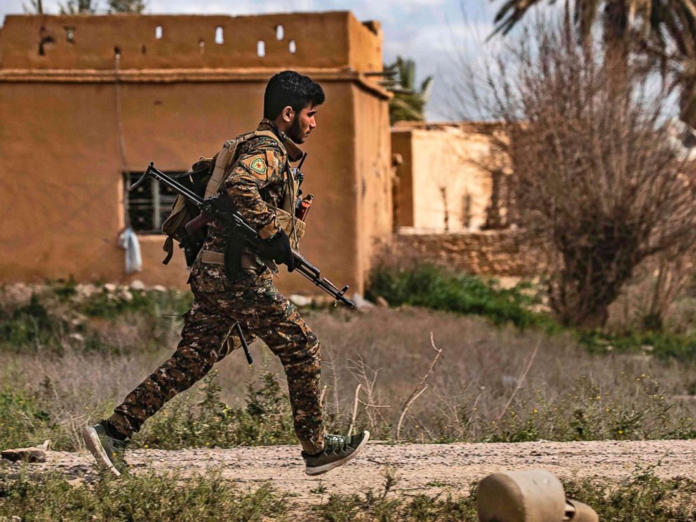 PHOTO: A member of the Syrian Democratic Forces (SDF) runs for cover during shelling on the Islamic State groups last holdout of Baghouz, in the eastern Syrian Deir Ezzor province, March 3, 2019.