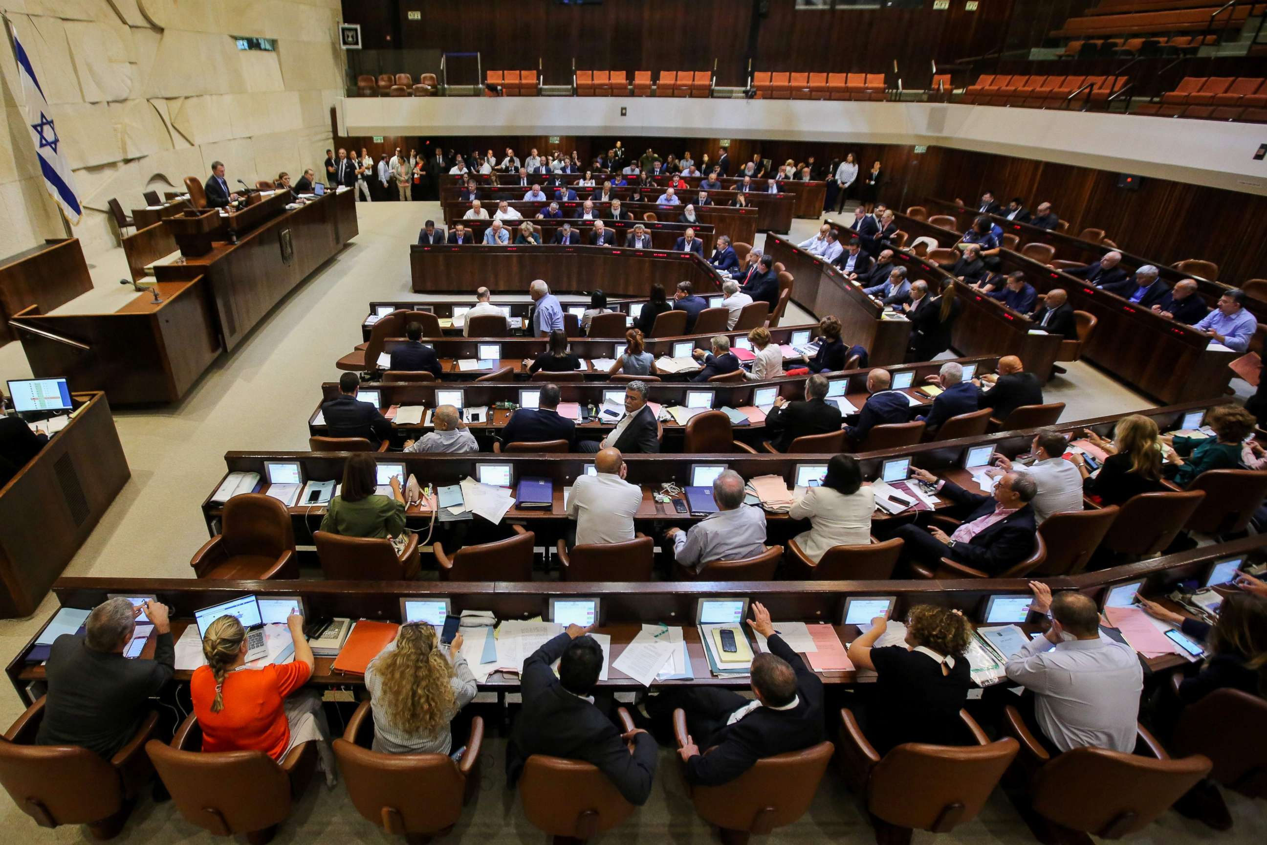 PHOTO: Israeli members of parliament attend the Knesset Plenary Hall session ahead of the vote on a National Law defining the country as the nation state of the Jewish people, July 18, 2018.
