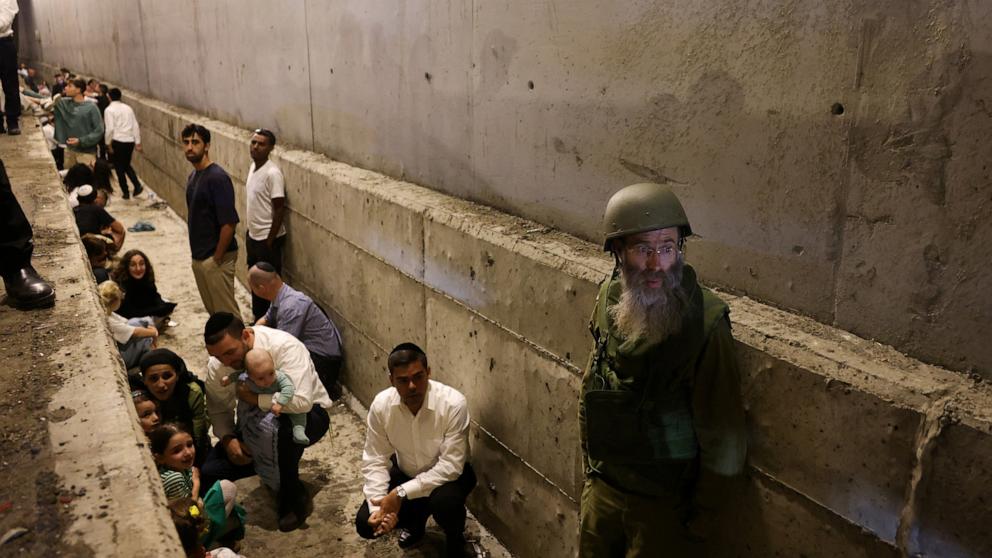 PHOTO: People take shelter during an air raid siren, amid cross-border hostilities between Hezbollah and Israel, in central Israel, Oct. 1, 2024. 