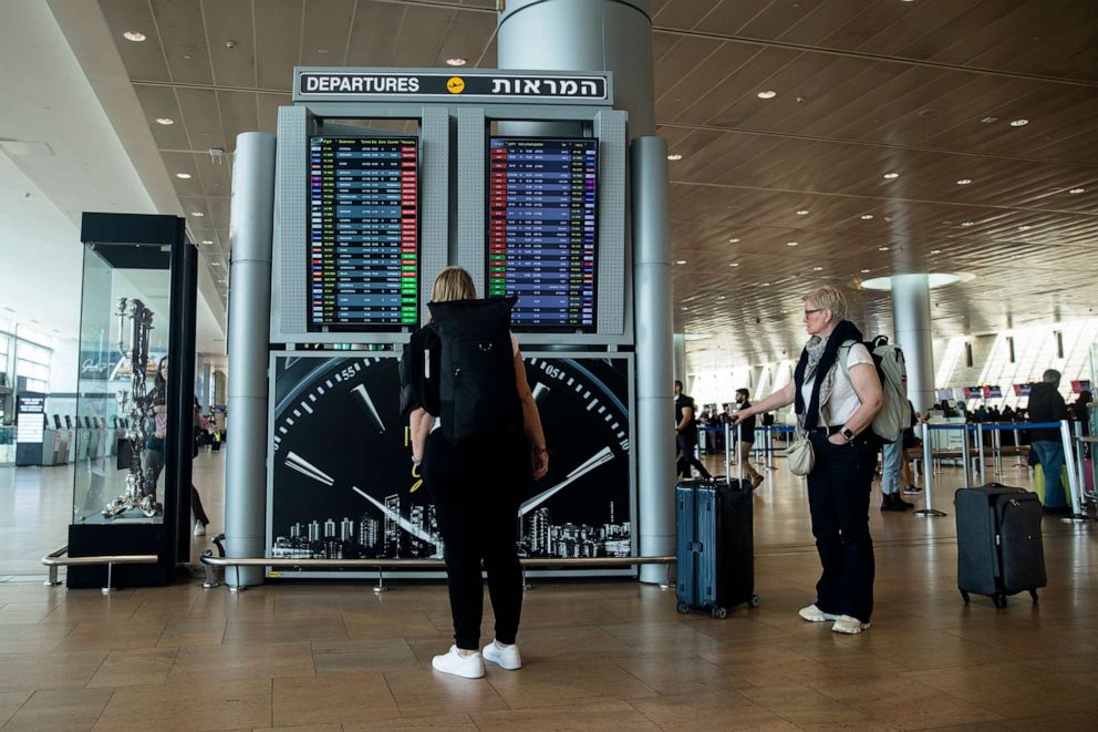 PHOTO: Passengers look at a departures flight board at Ben Gurion Airport showing cancellations of flights leaving Israel until further notice following widespread strikes in protest of the judicial overhaul on March 27, 2023, in Jerusalem, Israel.