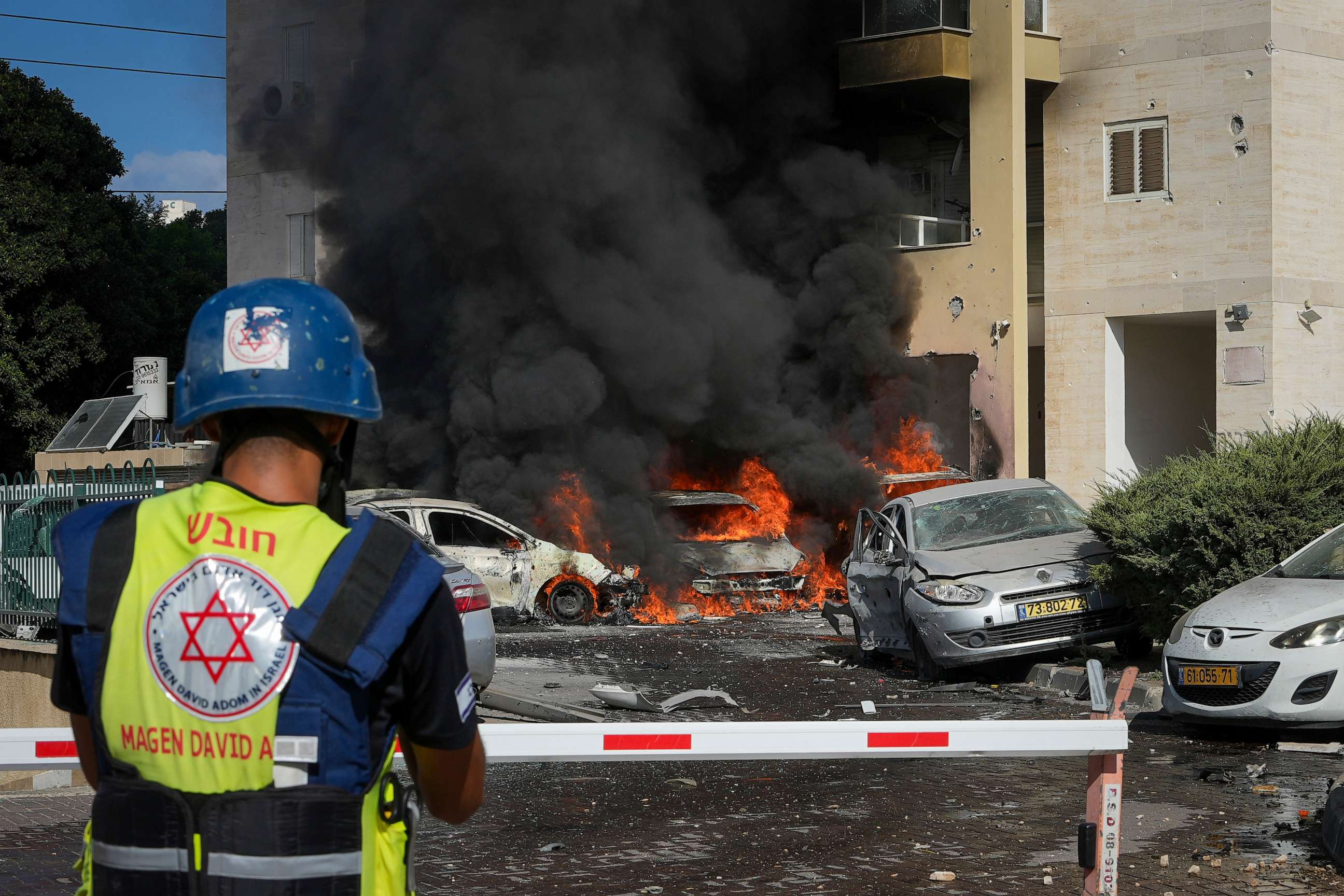 PHOTO: Cars are burning after a rocket fired from the Gaza Strip hit a parking lot and a residential building in Ashkelon, southern Israel, Saturday, Oct. 7, 2023. The rockets were fired as Hamas announced a new operation against Israel.
