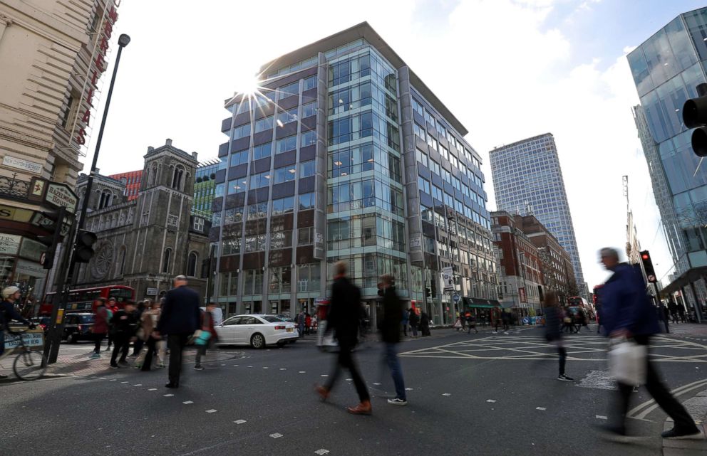 PHOTO: Pedestrians pass the building which houses the offices of Cambridge Analytica in central London, March 21, 2018.