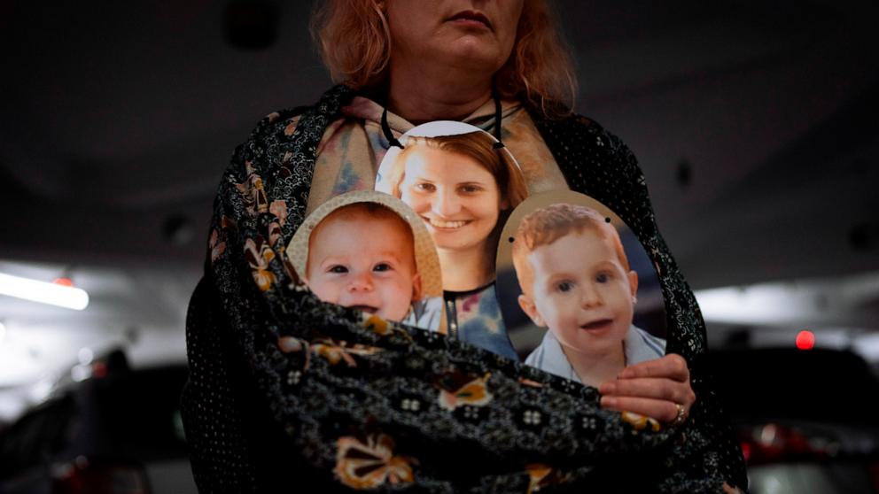 PHOTO: A woman holds a mask depicting the faces of Shiri Bibas and her sons Kfir and Ariel, Israelis who are being held hostage in the Gaza Strip by the Hamas, during a protest in Tel Aviv, Israel, Feb. 21, 2024. 