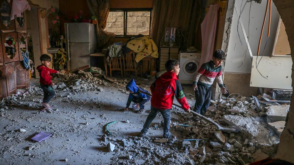 PHOTO: Palestinian children collect small pieces of debris following Israeli bombardment in Rafah in the southern Gaza Strip, Dec. 22, 2023.