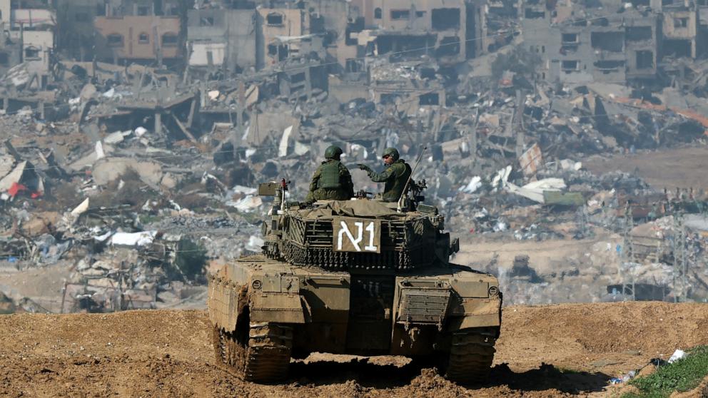 PHOTO: An Israeli tank moves to a position in front of damaged buildings in the Gaza strip amid continuing battles between Israel and the militant group Hamas, Jan. 19, 2024. 