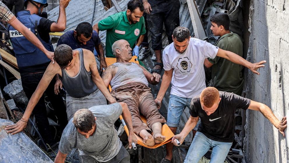 PHOTO: People carry on a gurney a man extricated from the rubble of a collapsed building following Israeli bombardment after his rescue in the Saftawi district in Jabalia in the northern Gaza Strip, Oct. 15, 2024.