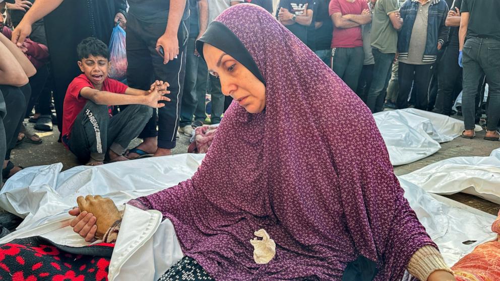 PHOTO: The wife of Palestinian Mohammed Abu Seif, who was killed in an Israeli strike, holds his hand during his funeral at Al-Aqsa hospital in Deir Al-Balah, in central Gaza Strip June 5, 2024.