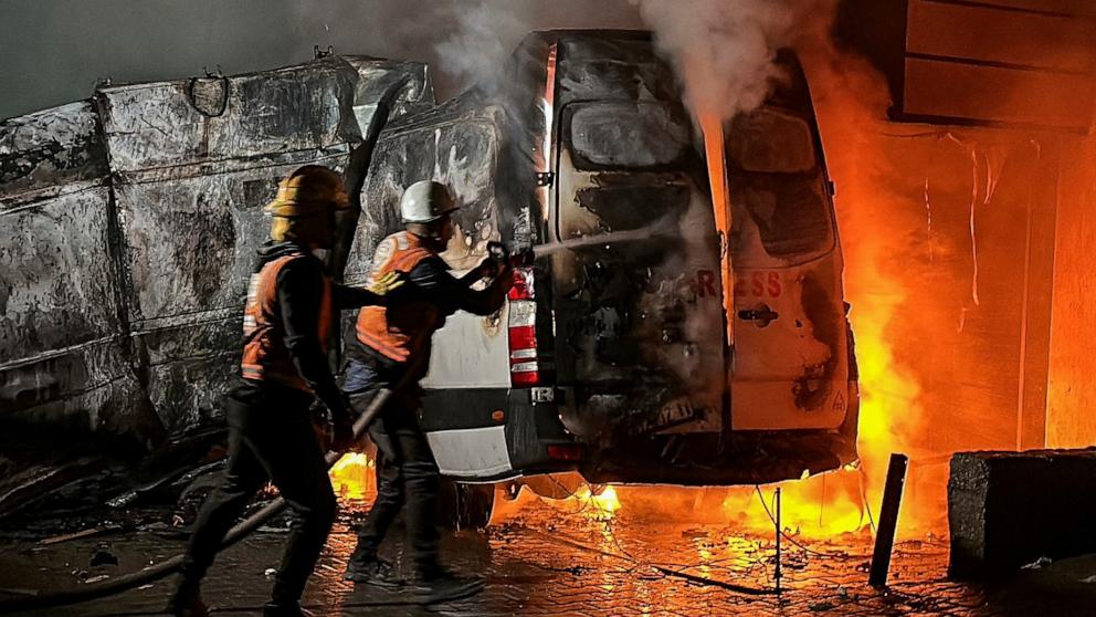 PHOTO: Civil Defense members put out a fire in a broadcast van following an Israeli strike that killed five journalists of Al-Quds Al-Youm television channel in central Gaza, Dec. 26, 2024. 