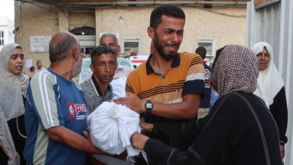 PHOTO: People transport the body of a family member from the al-Maamadani hospital for burial, following an Israeli strike that killed more than 90 people on a school sheltering displaced Palestinians in Gaza City, Aug. 10, 2024.