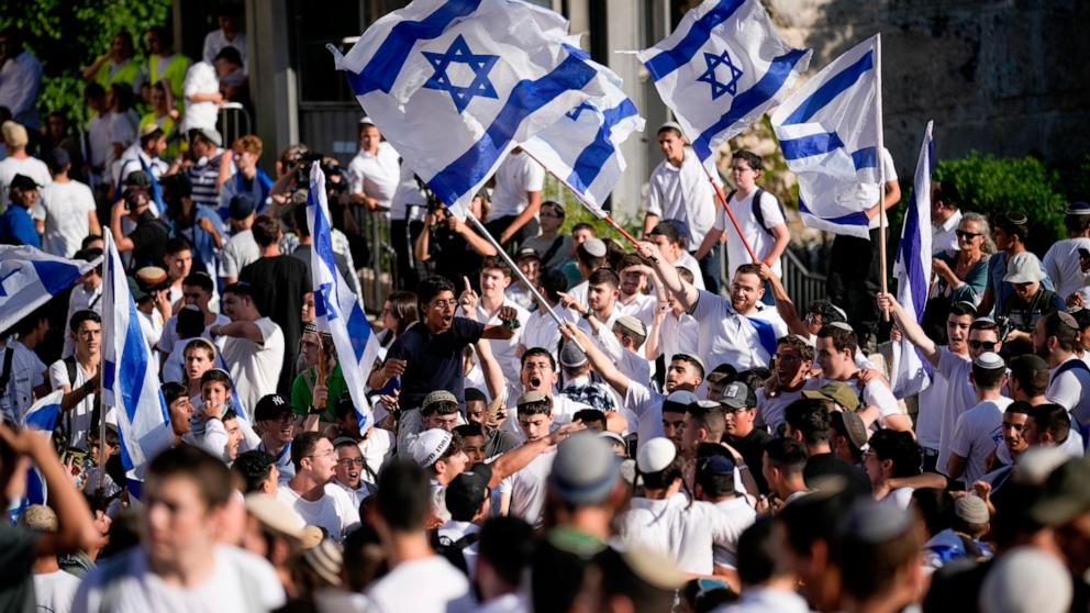 PHOTO: Israelis wave national flags during a march marking Jerusalem Day, an Israeli holiday celebrating the capture of east Jerusalem in the 1967 Mideast war, in front of the Damascus Gate of Jerusalem's Old City, June 5, 2024.
