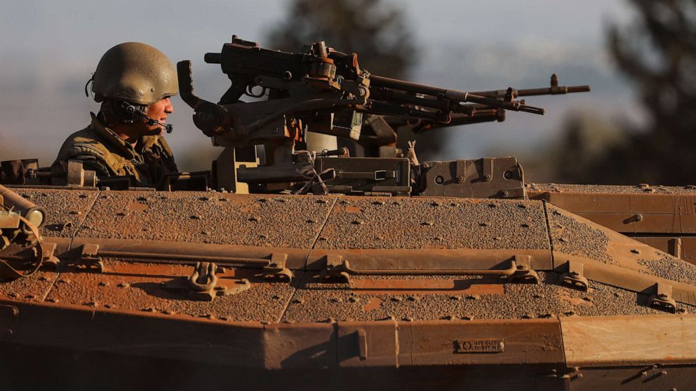 PHOTO: An Israeli soldier looks out from a tank during a military drill near Israel's border with Lebanon in northern Israel, Oct. 26, 2023.