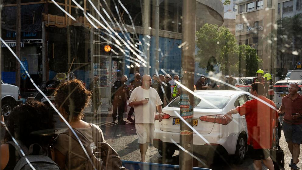 PHOTO: People are seen through a broken window next to the scene of an explosive drone attack in Tel Aviv, Israel, July 19, 2024.