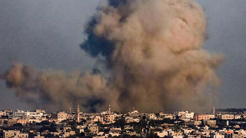 PHOTO: A smoke plume erupts over Khan Yunis from Rafah in the southern Gaza strip during Israeli bombardment, Dec. 26, 2023.