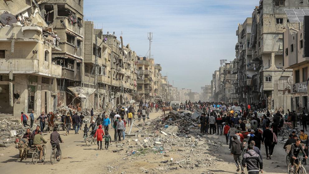 PHOTO: Palestinians gather in a street as humanitarian aid is airdropped in Gaza City, Mar. 1, 2024, amid the ongoing conflict between Israel and the Hamas militant group. 