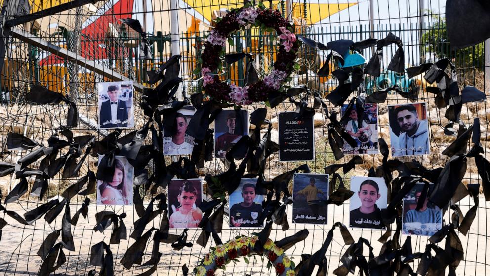 PHOTO: Portraits of the children who were killed two days ago, hang on the football stadium fence where a rocket landed, in the Druze village of Majdal Shams in the Israel annexed Golan Heights, July 29, 2024.