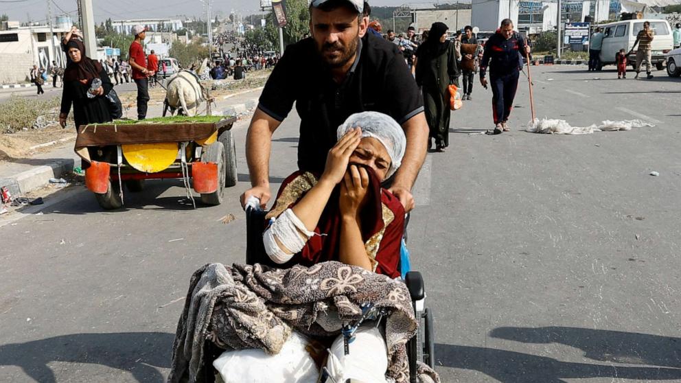 PHOTO: A Palestinian woman, who was injured in an Israeli strike and was staying at Al Shifa hospital, moves southward after fleeing north Gaza, Nov. 10, 2023.