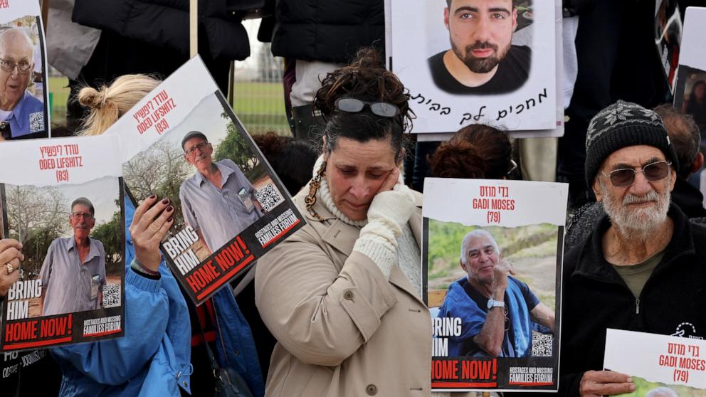 PHOTO: Relatives of Israeli hostages held by the Palestinian Hamas movement carry pictures of their loved ones in Kibbutz Nirim along the Gaza border as their time in captivity nears to 100 days, Jan. 11, 2024. 