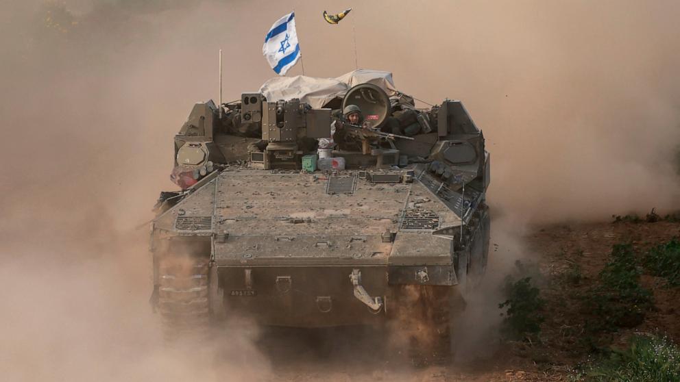 PHOTO: This picture taken from Israel near the border with the Gaza Strip shows an Israeli army soldier sitting on an armored personnel carrier as it moves out of Gaza, Feb. 26, 2024.