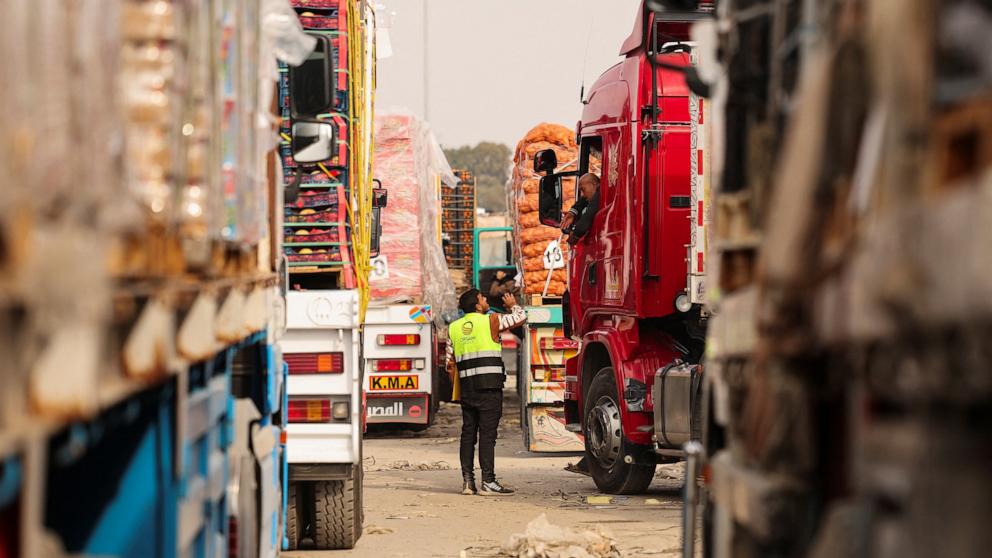PHOTO: A truck driver talks with a worker as he waits to go through the Rafah border crossing to enter the Gaza Strip, amid a ceasefire between Israel and Hamas, in Rafah, Egypt, Jan. 28, 2025.