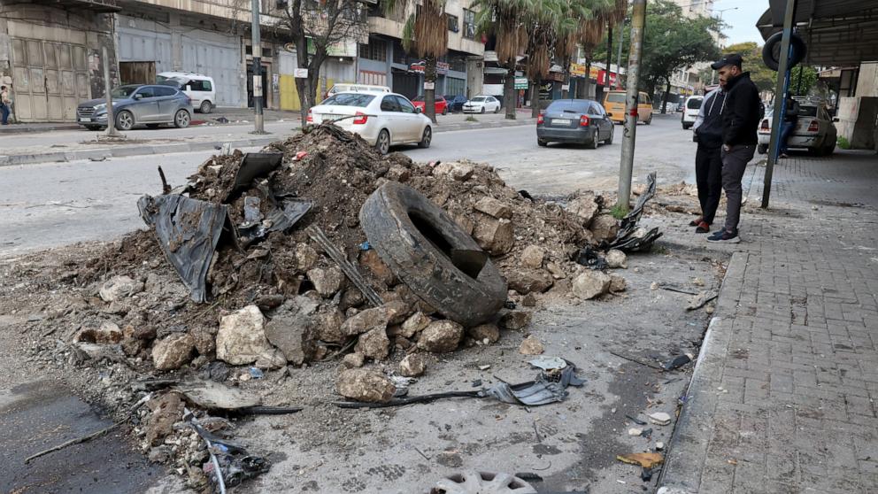PHOTO: Palestinians inspect the damage at the site of an air strike on Balata refugee camp, near the West Bank city of Nablus, Jan. 17 2024. 