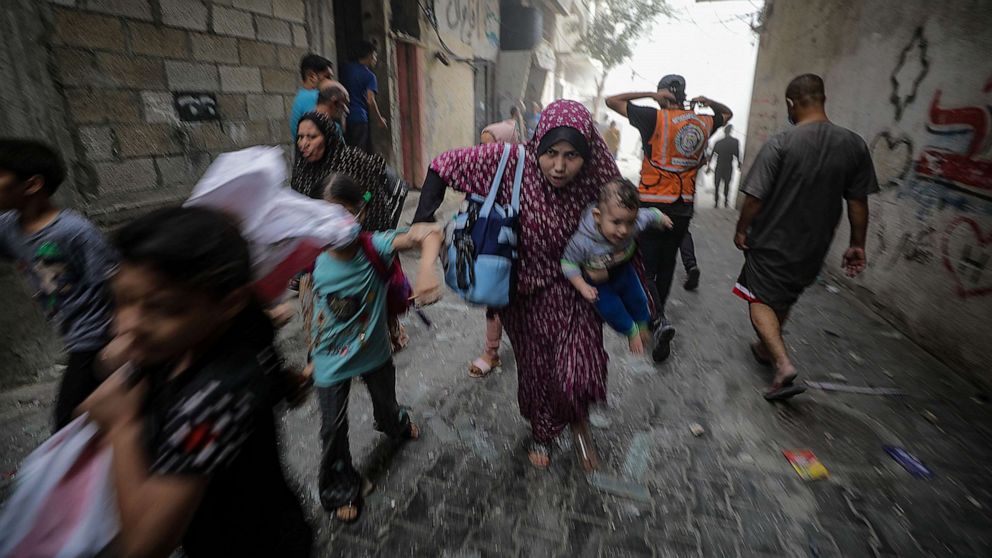 PHOTO: Palestinians flee following an Israeli air strike in Gaza City, October, 23, 2023.