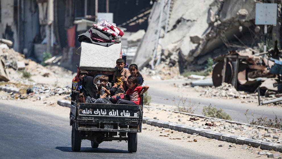 PHOTO: Children sit in the back of a small vehicle as Palestinians flee with their belongings Deir el-Balah in the central Gaza Strip, Aug. 16, 2024.