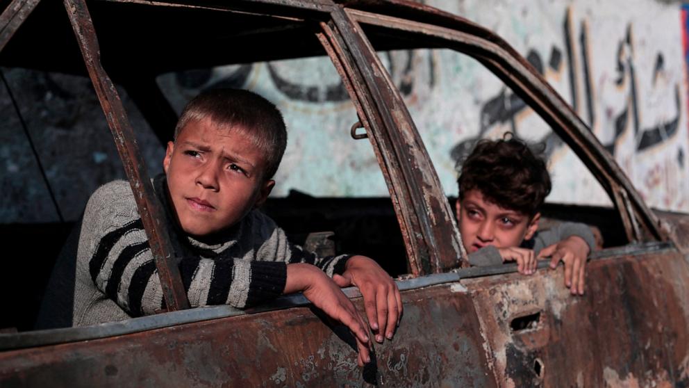 PHOTO: Children sit in a destroyed car in Rafah, on the southern Gaza Strip, Feb. 28, 2024, amid ongoing battles between Israel and the Palestinian militant group Hamas. 