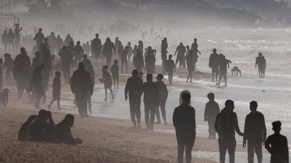 PHOTO: Palestinians gather on a beach in the hope of getting aid air-dropped over Gaza, amid the ongoing the conflict between Israel and Hamas, in the southern Gaza Strip Feb. 27, 2024. 