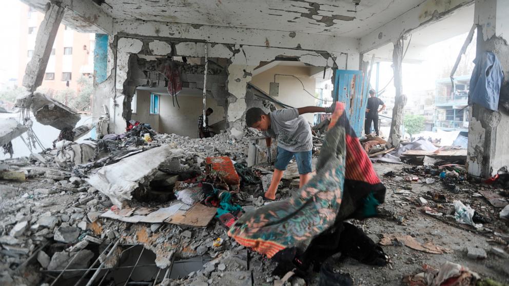 PHOTO: Palestinians look at the aftermath of the Israeli strike on a U.N.-run school that killed dozens of people in the Nusseirat refugee camp in the Gaza Strip, June 6, 2024.