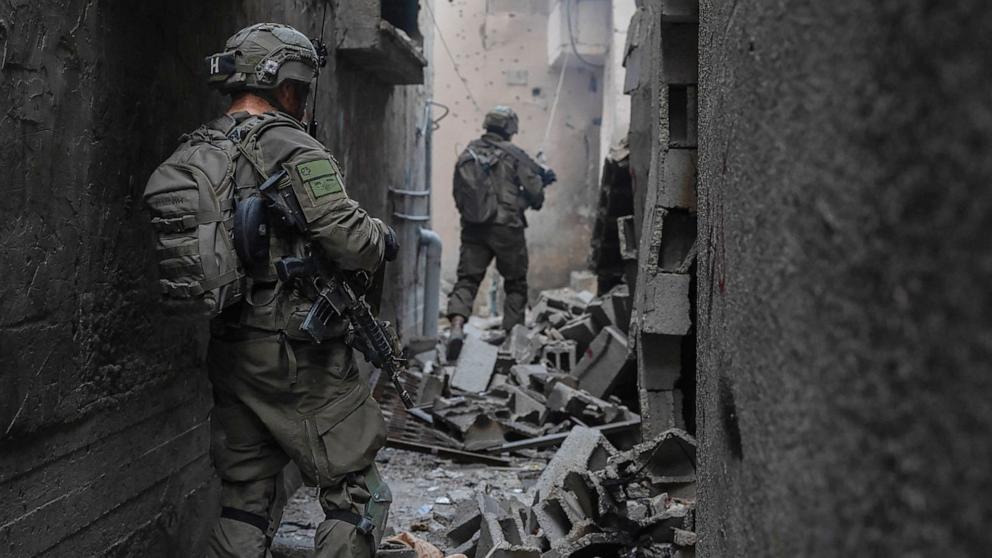 PHOTO: Israeli soldiers walk through an alley during military operations in the Gaza Strip, May 27, 2024.