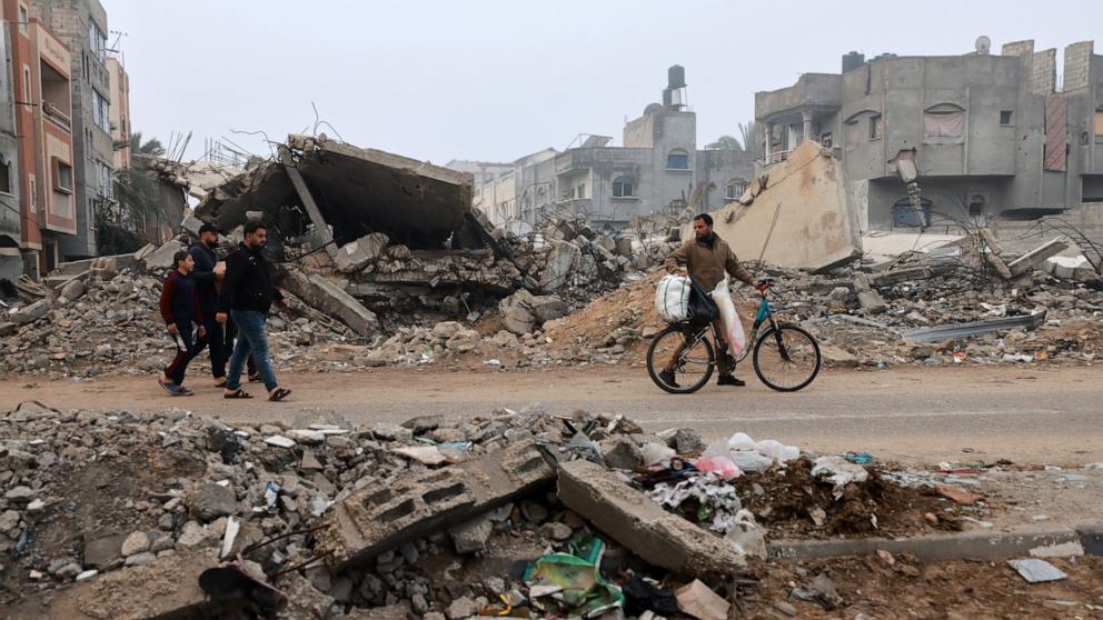 PHOTO: Men walk along a street ravaged by Israeli bombing in Rafah in the southern Gaza Strip, Feb. 9, 2024, amid the ongoing conflict between Israel and the Palestinian militant group Hamas.