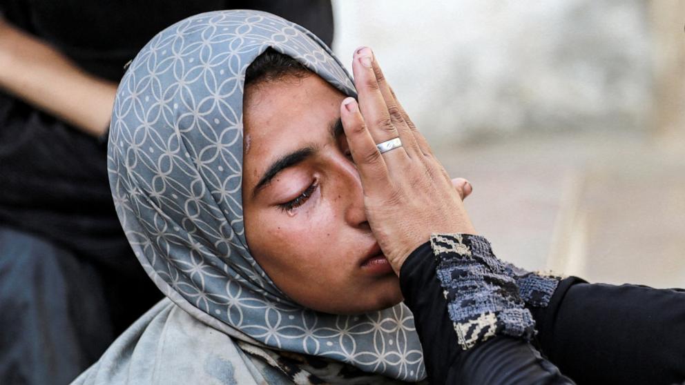 PHOTO: Relatives of Eyad Hegazi, a 10-year-old Palestinian child displaced from Shejaiya who died of malnutrition, comfort each other as they mourn outside the Aqsa Martyrs hospital in Deir el-Balah in the central Gaza Strip on June 14, 2024.