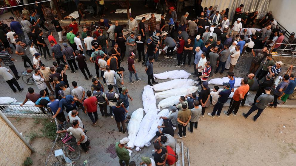 PHOTO: Shrouded bodies are laid down at the al-Maamadani hospital, following an Israeli strike that killed more than 90 people on a school sheltering displaced Palestinians in Gaza City, Aug. 10, 2024