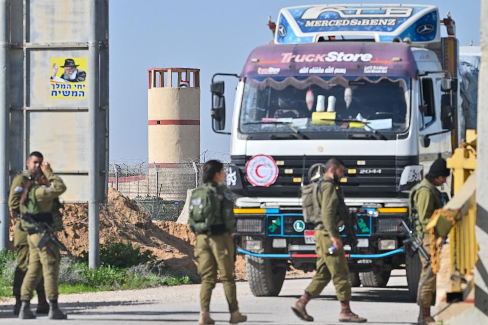 PHOTO: Trucks carrying humanitarian aid enter the Kerem Shalom Crossing before being checked and going into Gaza, after arriving from Egypt on Dec. 22, 2023 in Kerem Shalom, Israel.