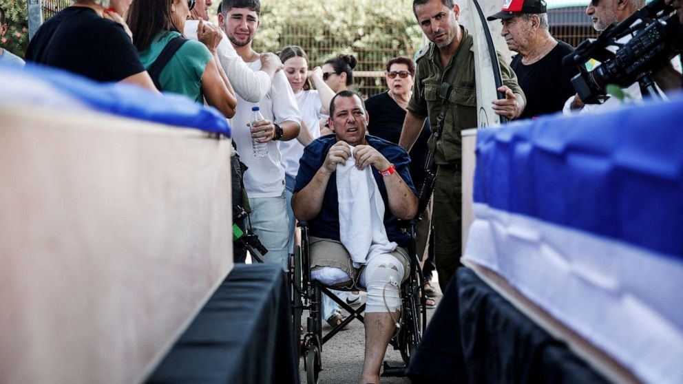 PHOTO: Avida Bachar, who was injured following a deadly attack by Hamas gunmen from Gaza in Kibbutz Beeri, mourns during the funeral of his wife Dana and his son Karmel at Kvutzat Shiller, Israel Oct. 24, 2023.