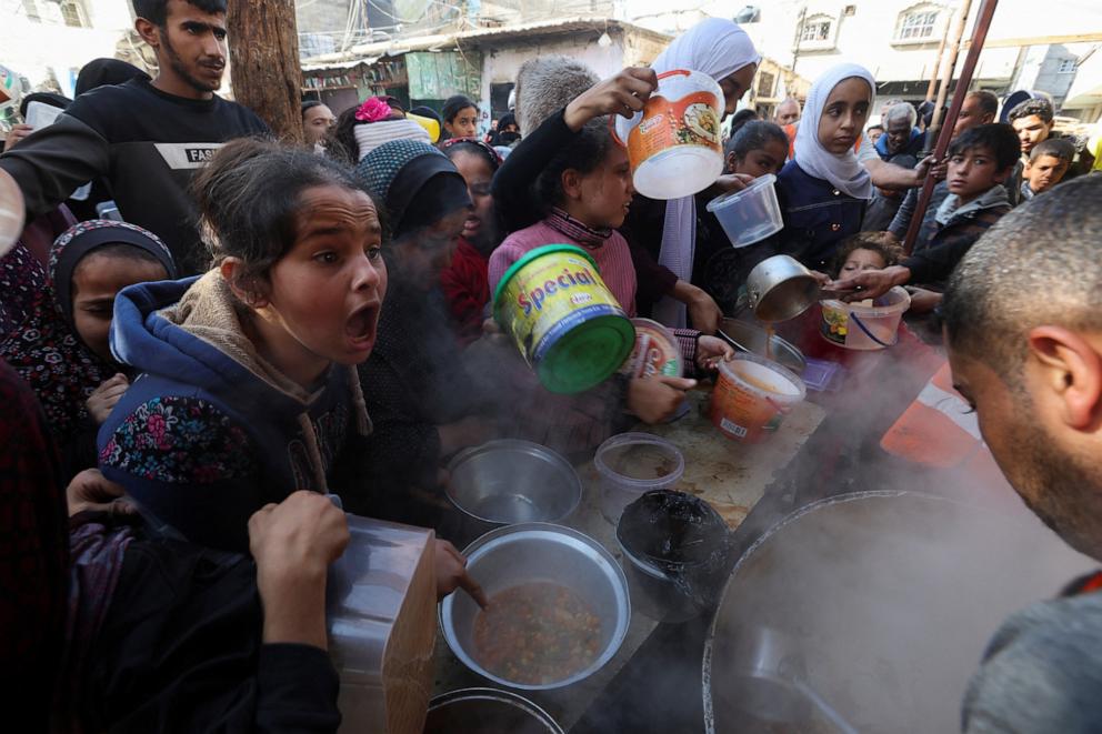 PHOTO: A Palestinian child reacts, while people gather to get their share of charity food offered by volunteers, amid food shortages, as the conflict between Israel and the Palestinian Islamist group Hamas continues, in Rafah, Gaza Strip, Dec. 2, 2023.