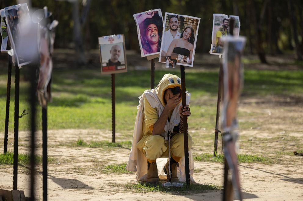 PHOTO: A man grieves his friends at an installation on the site of the Nova festival, where people were killed and kidnapped during the October 7 attack by Hamas gunmen from Gaza, in Reim, in Southern Israel,  Dec. 22, 2023. 