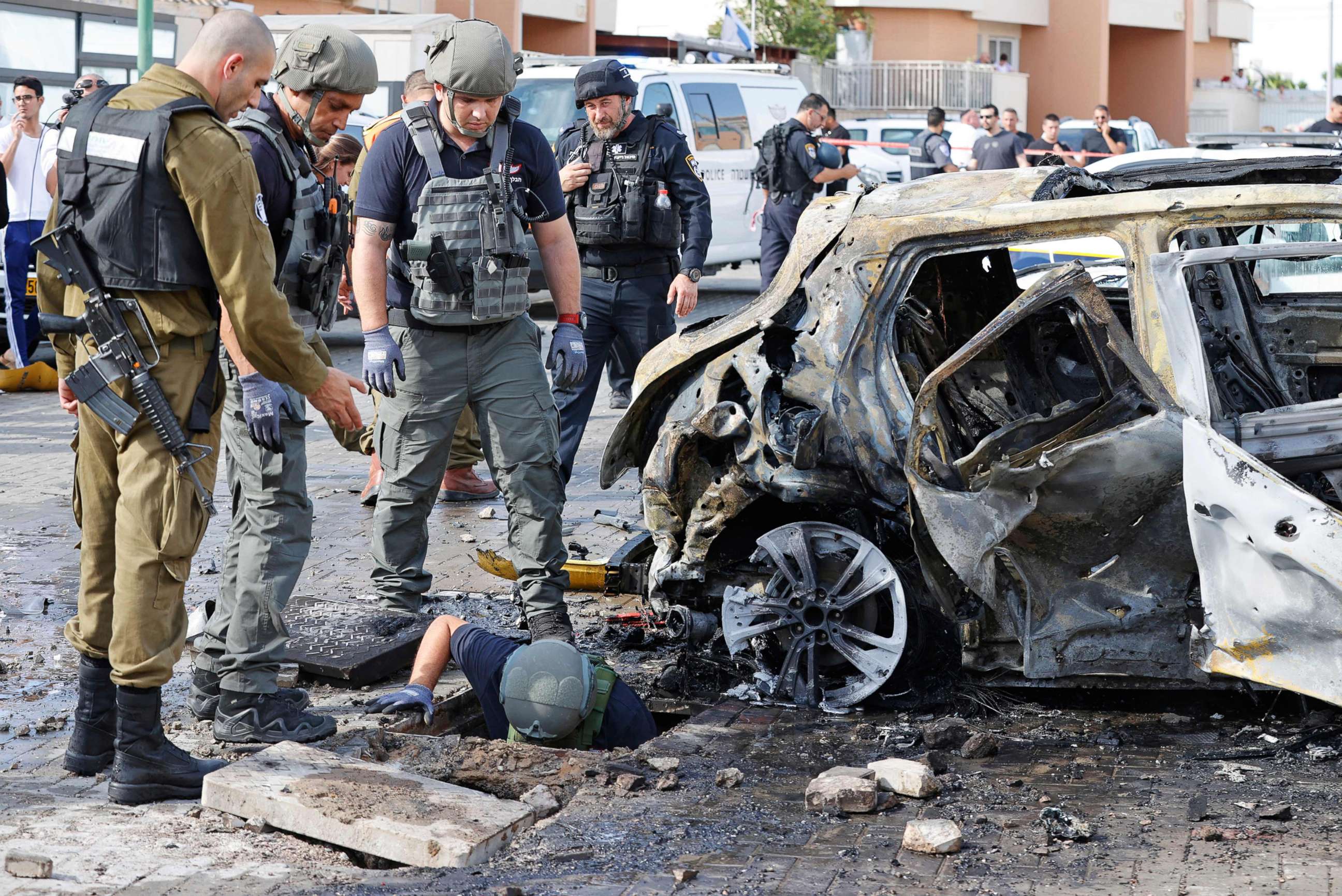 PHOTO: Israeli security forces inspect a site in the southern Israeli city of Ashkelon following a rocket attack fired from the Gaza Strip, May 16, 2021.