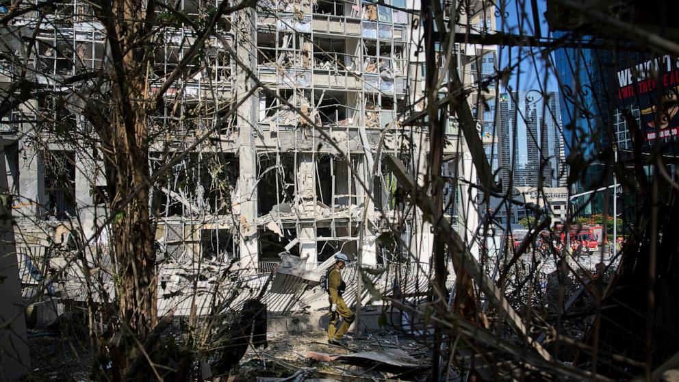 PHOTO: Rescue workers and military personnel inspect the site of a direct hit from an Iranian missile strike in Ramat Gan, Israel, June 19, 2025.