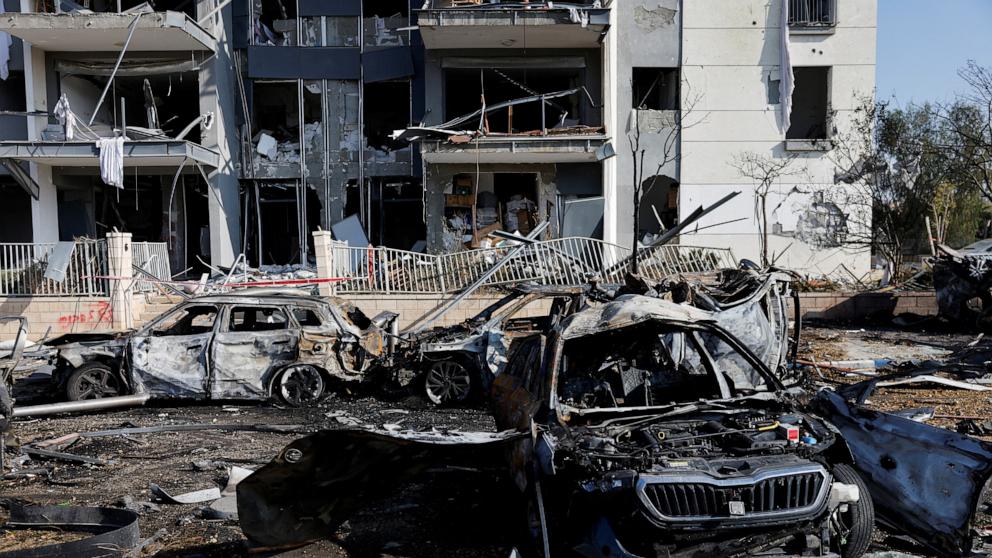 PHOTO: A view of burnt cars and a damaged residential building at an impact site following Iran's missile strike on Israel, in Be'er Sheva, Israel, June 20, 2025.