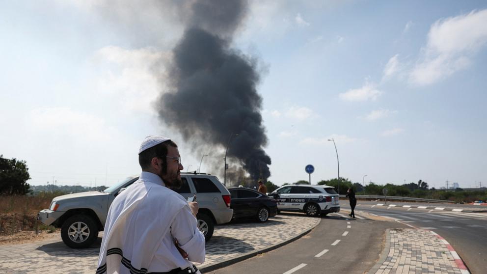 PHOTO: An Israeli man looks on, as smoke rises following a missile attack from Iran, in Herzliya, Israel, June 17, 2025.