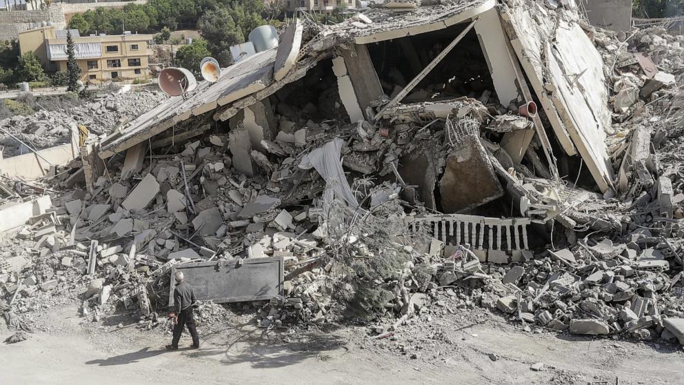 PHOTO: A man walks past a building that was destroyed during an Israeli airstrike that targeted the southern Lebanese village of Zeita a day earlier, Oct. 14, 2024.