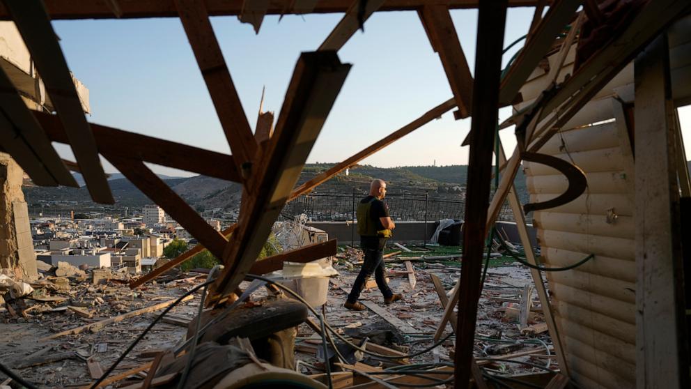 PHOTO: Israeli security forces survey damage to a home struck by a rocket fired from Lebanon in the town of Majd al-Krum, northern Israel, Oct. 16, 2024. 