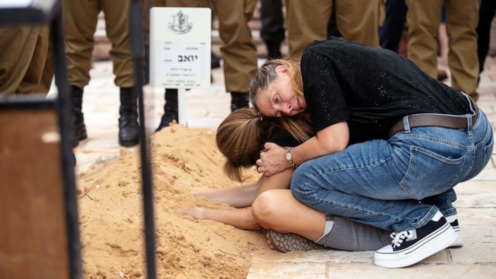 The mother of Israeli soldier Sergeant Yoav Agmon, who was killed in a drone attack from Lebanon is comforted as she mourns during his funeral, in Binyamina-Givat Ada, Israel, Oct. 15, 2024.