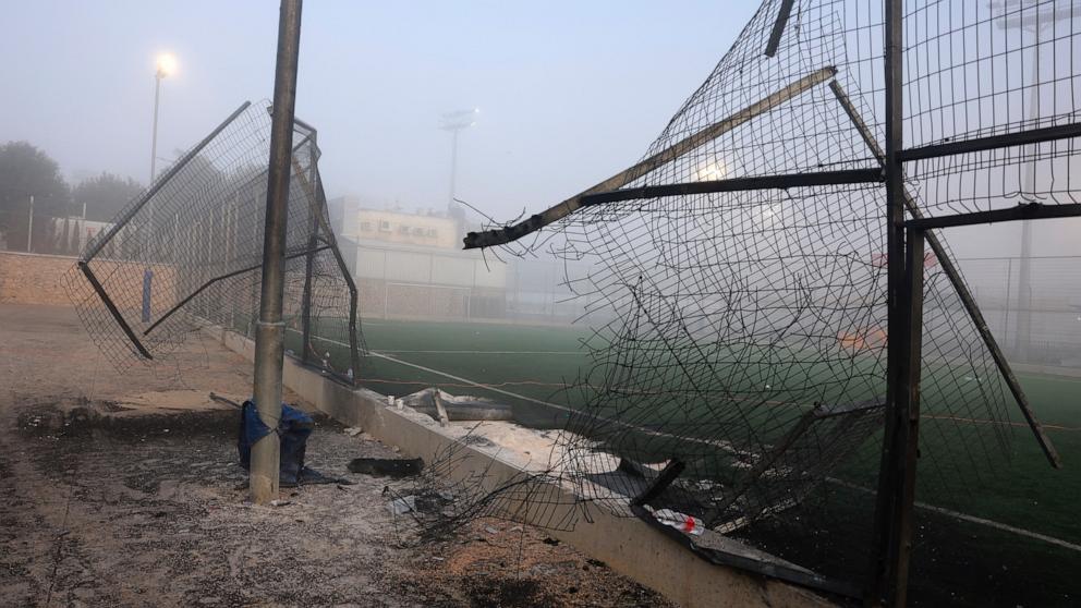 PHOTO: A damaged gate and debris are seen at a football pitch after a reported strike from Lebanon fell in Majdal Shams village in the Israeli-annexed Golan area on July 28, 2024.