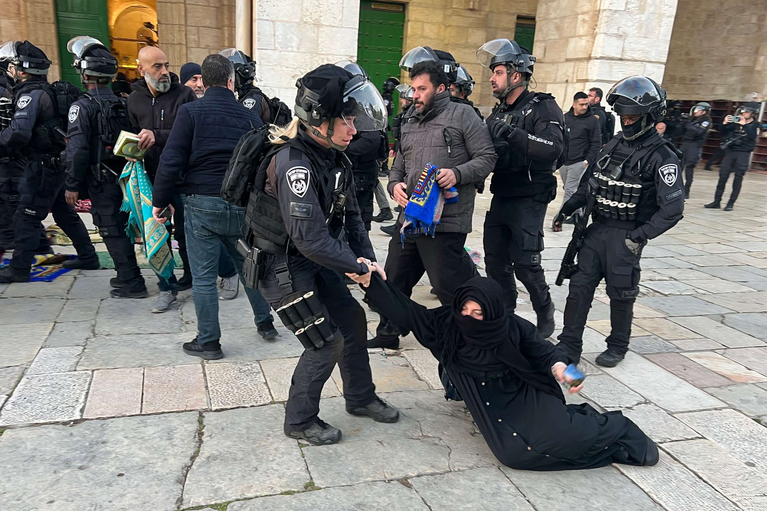 PHOTO: Israeli security forces remove Palestinian Muslim worshippers sitting on the grounds of the Al-Aqsa mosque compound in Jerusalem, early on April 5, 2023 during Islam's holy month of Ramadan.