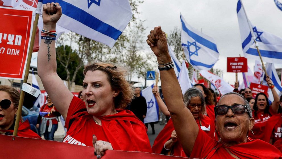 PHOTO: Protestors attend a demonstration after Israeli Prime Minister Benjamin Netanyahu dismissed the defense minister amid his government's plan to overhauld the judicial system, in Jerusalem, March 27, 2023.