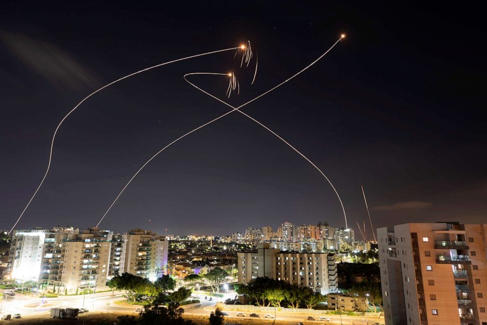 PHOTO: Streaks of light are seen as Israel's Iron Dome anti-missile system intercept rockets launched from the Gaza Strip towards Israel, as seen from Ashkelon, Israel, May 13, 2021. 