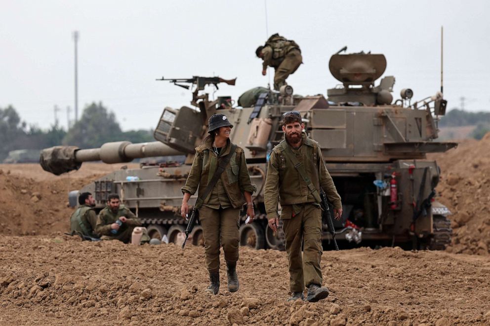 PHOTO: Israeli soldiers take positions in their armored vehicles near the border with Gaza in southern Israel on Oct. 9, 2023.